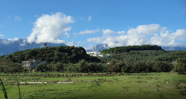 A rendering of the SNF General Hospital of Sparta building is added atop a hill in a verdant landscape